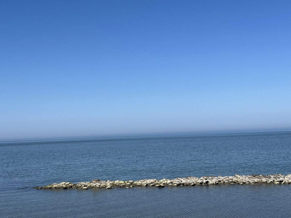 Ocracoke Island's pristine undeveloped shoreline with calm Atlantic waters and barrier island dunes, North Carolina